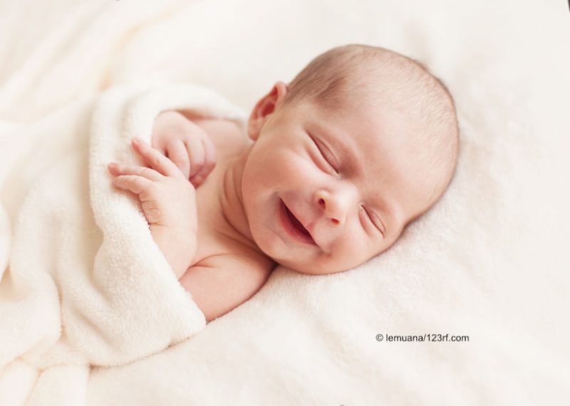 47381298 - newborn baby girl asleep on a blanket.